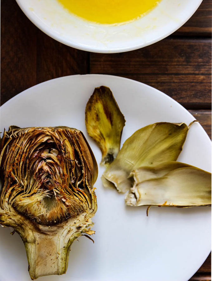 roasted half of a artichoke on a plate