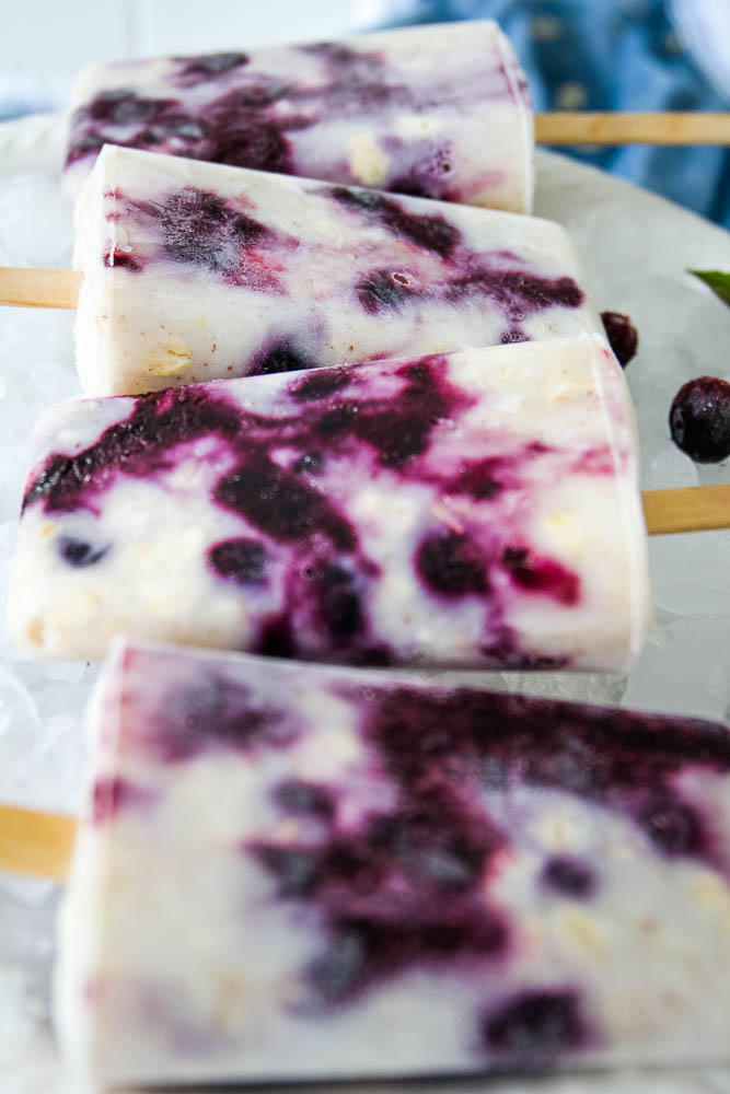 blueberry yogurt popsicles stacked in a row.