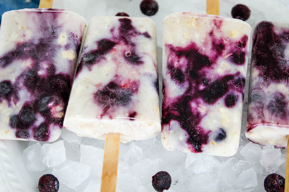 blueberry yogurt popsicles ontop of crushed ice.