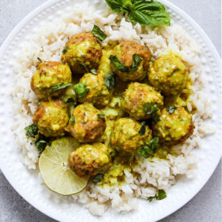 creamy coconut curry chicken meatballs flat lay shot on a white plate