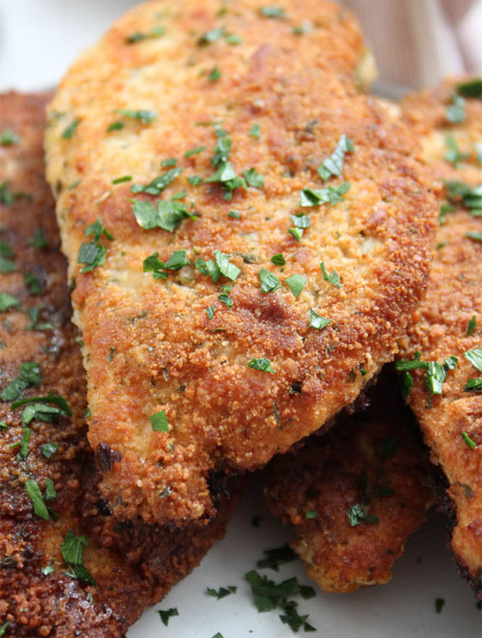 Close up view of parmesan crusted chicken to show the crispy and crunchy texture.