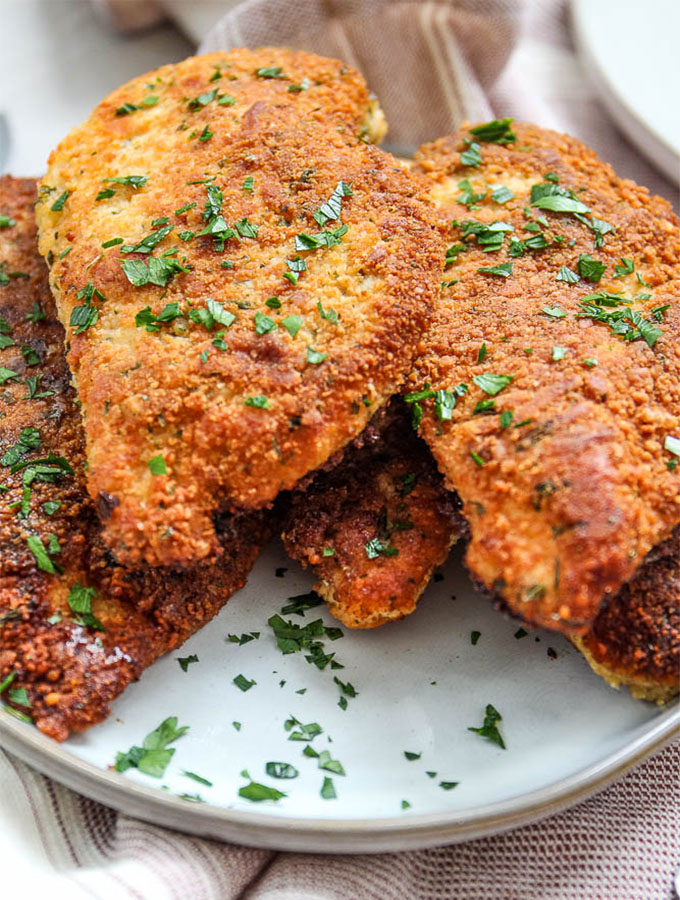 Parmesan crusted chicken is topped with fresh parsley for looks and taste!