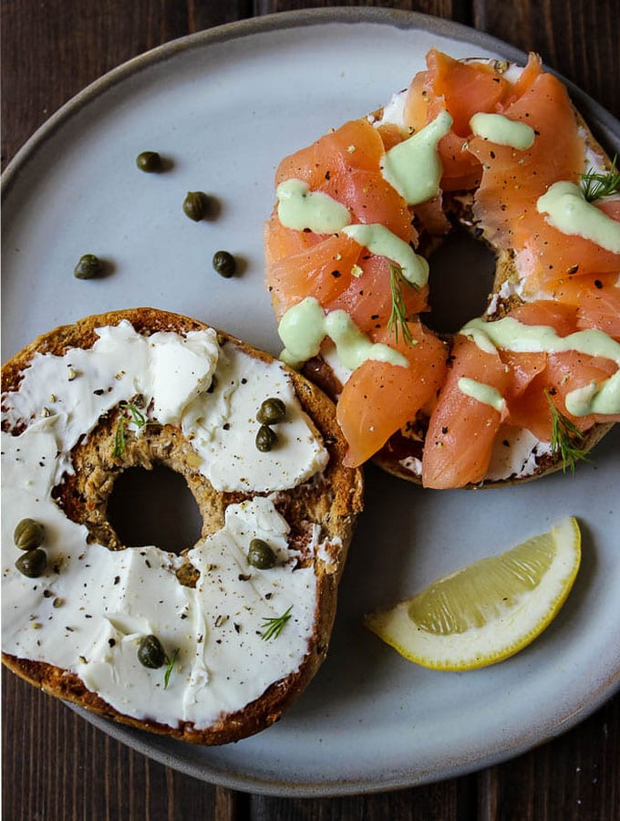 Lox and bagels is made with smoked salmon, cream cheese, toasted bagels, capers, and topped with a cucumber lemon sauce for added flavor!