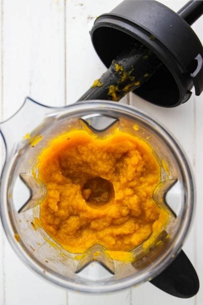 Pumpkin puree is made by halving the sugar pie pumpkins, roasting them in the oven, then blending the flesh in a blender.
