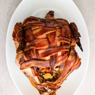 Bacon wrapped turkey breasts is fully cooked with crunchy bacon and stuffed with carrots, celery, onion, and herbs.