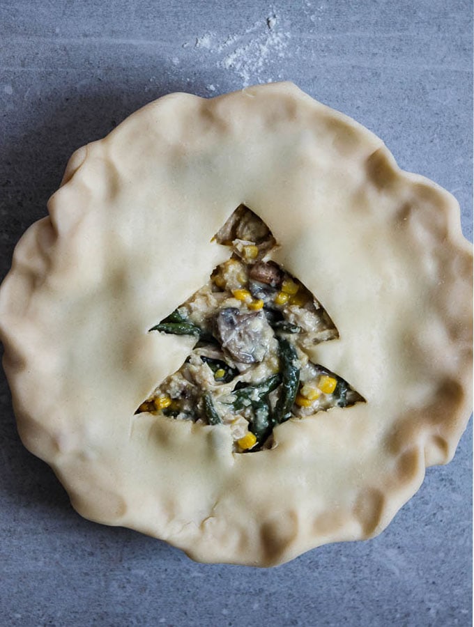 Leftover turkey pot pie is maded with Thanksgiving left overs and has a christmas tree cut out in the center of it for pie ventilation.