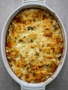 Potato au gratin is freshly baked with a crispy top layer of parmesan and mozzarella cheese.