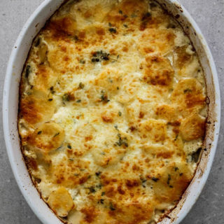Potato au gratin is freshly baked with a crispy top layer of parmesan and mozzarella cheese.