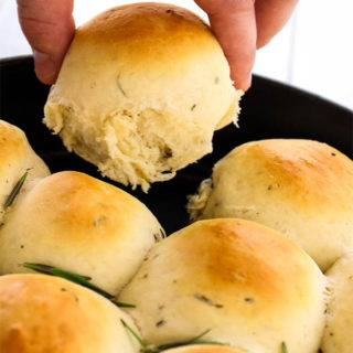 Rosemary Garlic Dinner Rolls are pulled apart to show texture and fluffiness.
