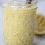 White wine vinaigrette is jarred in a small mason jar with a spoon to show the texture.