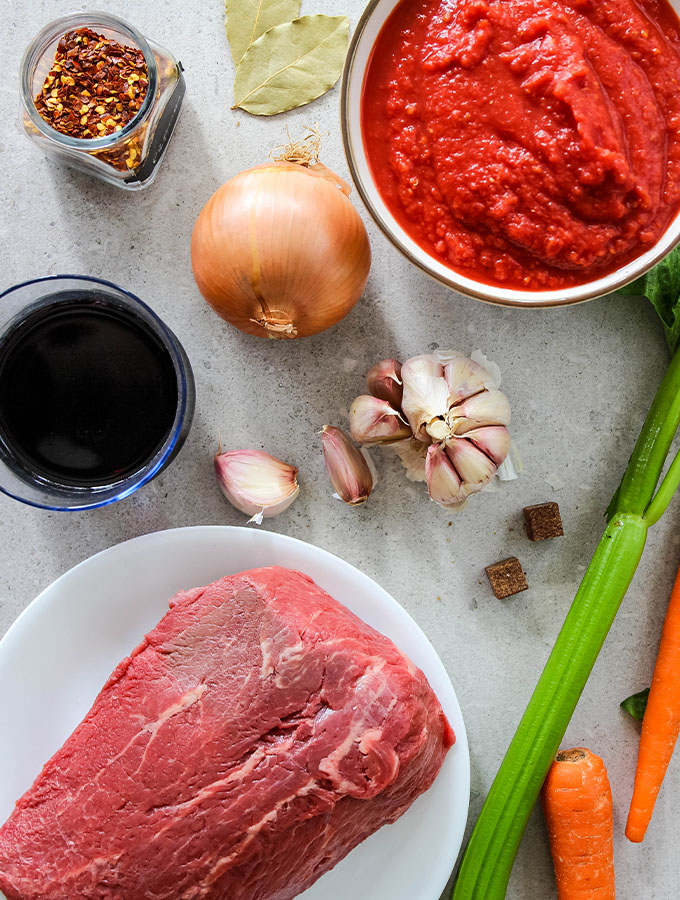 Instant Pot Beef Ragu Pasta ingredients are displayed in a flat lay photo.