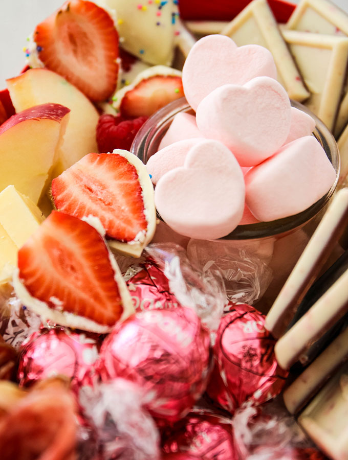 Close up shot is taken of the heart shaped marshmallows used for this Valentine's day charcuterie board to show texture and color.