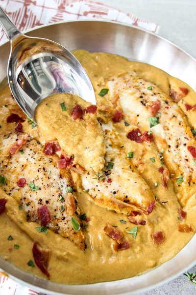 Dijon mustard chicken is topped with more sauce to show the creamy texture.