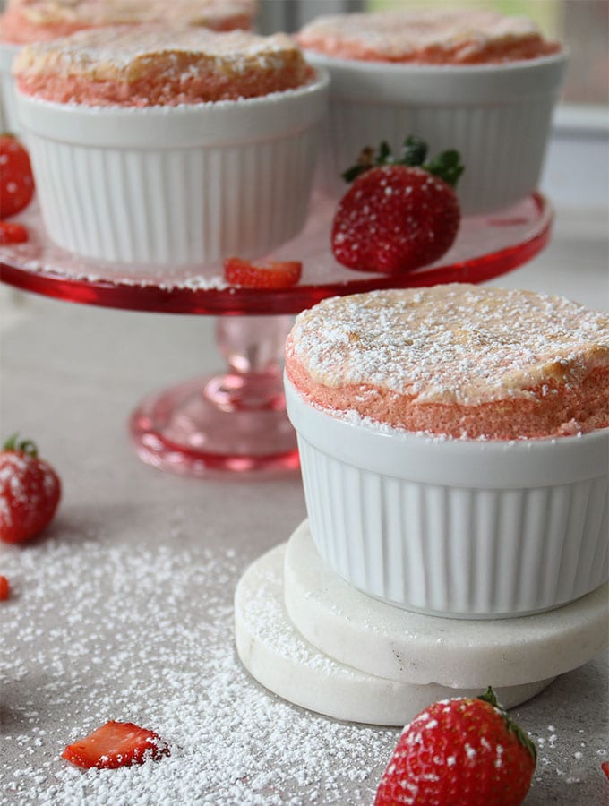 Strawberry Soufflé is baked in ramekins and dusted with powdered sugar.