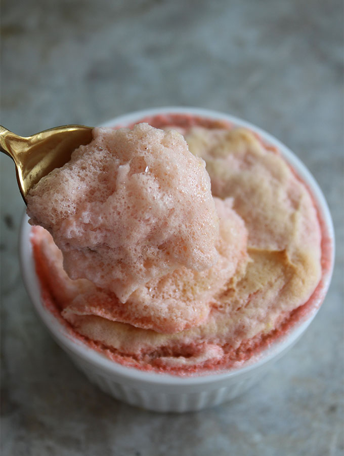 Strawberry Soufflé is scooped in a spoonful to show fluffy texture.