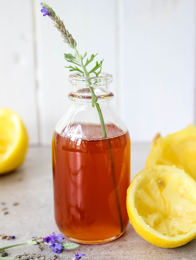 Lavender lemon simple syrup is bottled in a glass jar.