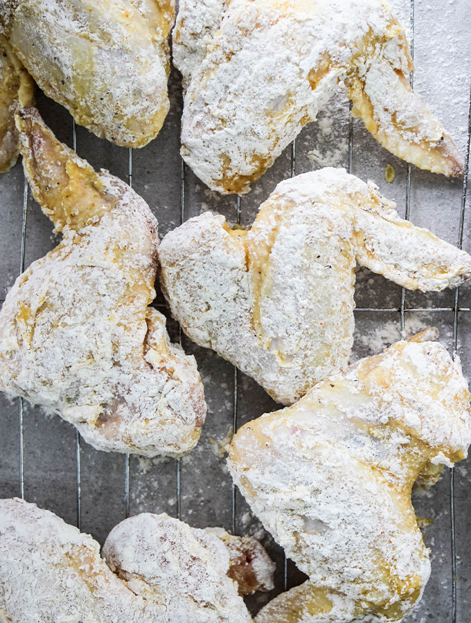 Lemon pepper chicken wings are dipped in a flour batter,