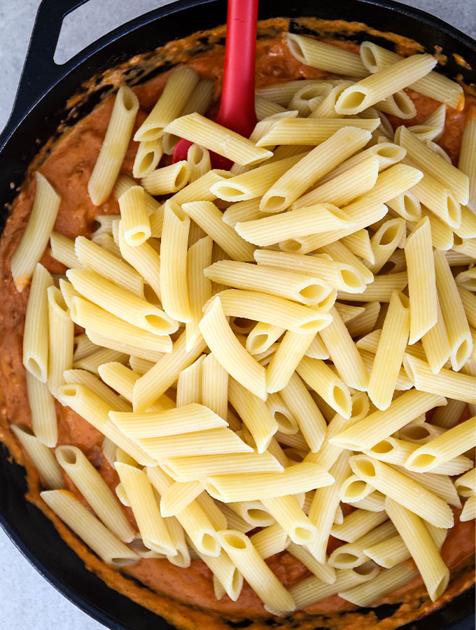 Penne pasta is tossed in the vodka sauce in one pan.