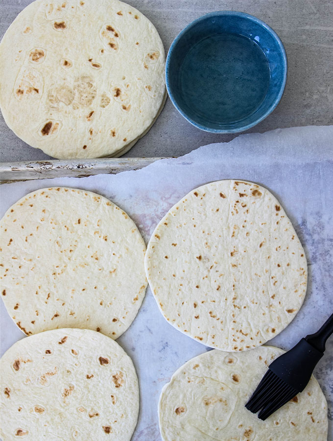 Flour tortillas are brushed with melted coconut to help them crisp.