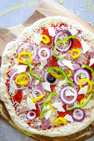 Italian Sub Pizza is topped with all the ingredients and is about to be baked.