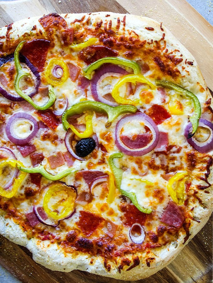 Italian Sub Pizza is baked to a golden brown, then placed on a pizza pan.