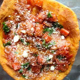 Deep Fried Neapolitan Pizza is baked and topped with sautéd tomatoes, basil and parmesan cheese.