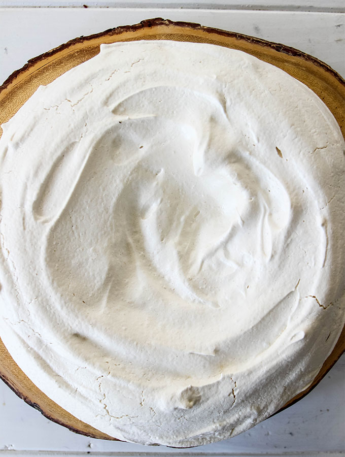 Fresh Berry Pavlova is baked to a pale creamy color and has a hard outside.