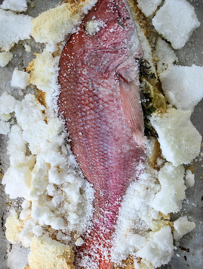 Salt Crusted Fish is baked, then the crust is cracked off of it.
