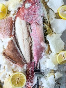 Salt Crusted Fish is served with lemon wedges to add more flavor.