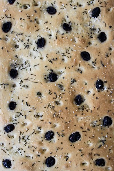 Easy Olive and Herb Focaccia is baked to a golden brown color.