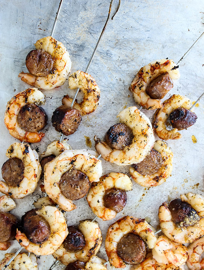 Grilled Italian Sausage and Shrimp Kabobs are grilled and placed on a baking sheet.