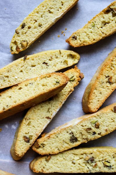Orange Pistachio Biscottis are played on parchment paper after they are baked.
