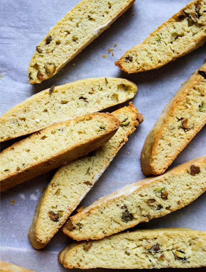 Orange Pistachio Biscottis are played on parchment paper after they are baked.