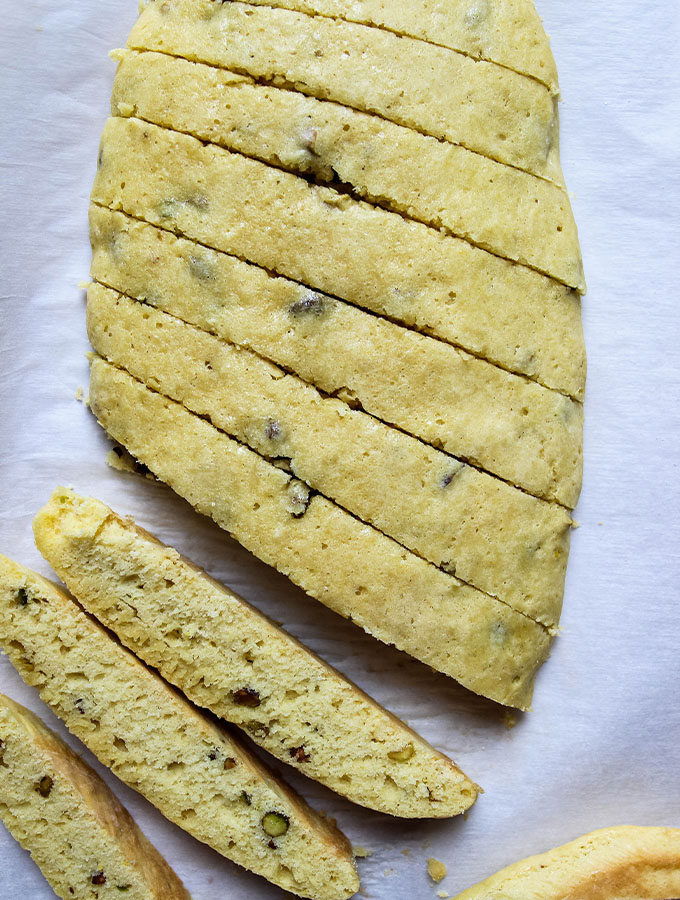 Orange Pistachio Biscottis are sliced after they finished with their first bake.