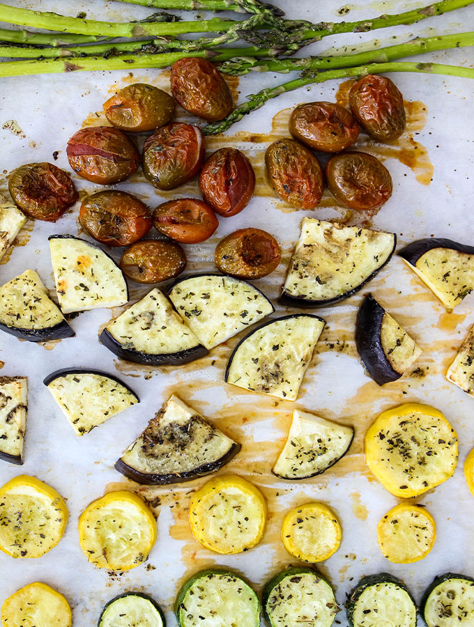 Vegetables are roasted on a baking sheet to make Roasted Italian Vegetables with Parmesan Polenta.