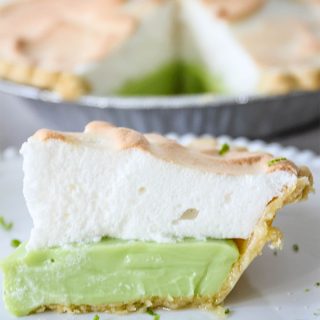 A slice of key lime pie is plated on a white plate.