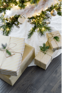 Wrapped presents are set under the tree for a Christmas in July celebration.
