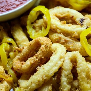 Rhode Island style calamari is deep fried and plated with banana pepper rings.