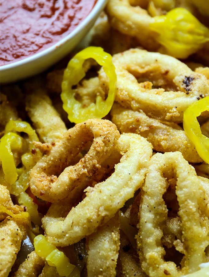 Rhode Island style calamari is deep fried and plated with banana pepper rings.