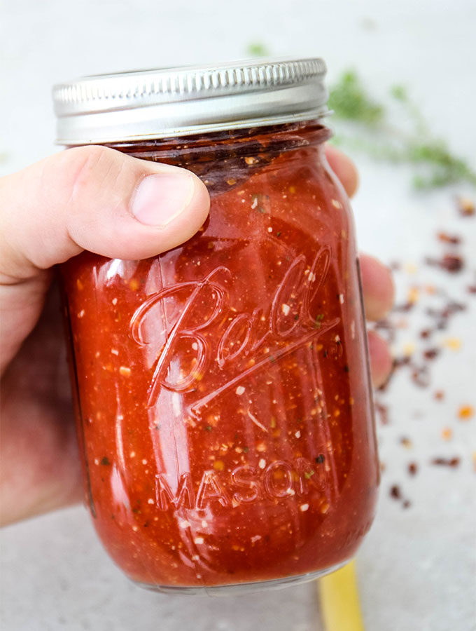 Easy Five Minute Marinara Sauce is bottled in a glass mason jar.