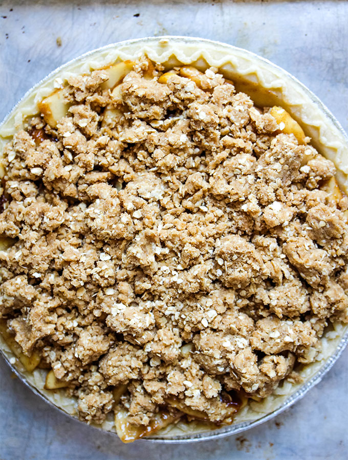 The Dutch apple pie is plated on a baking sheet before it is baked.