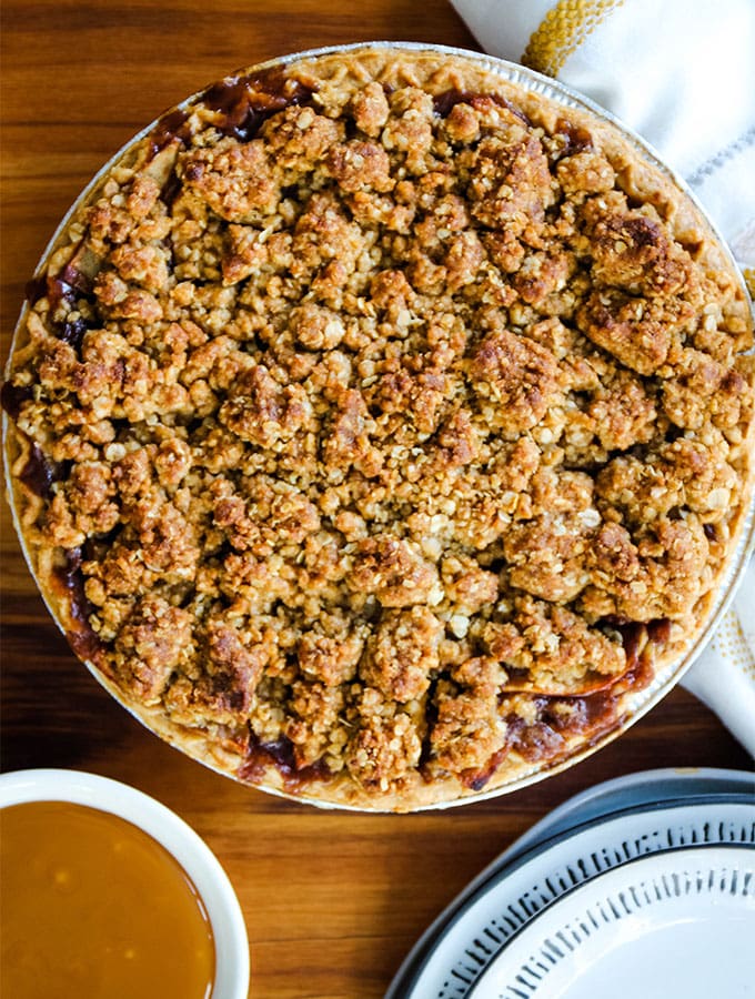 The Dutch apple pie is baked, then plated next to a bowl of caramel that will be used for drizzling.