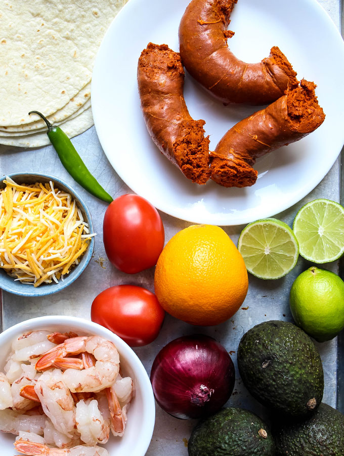 Chorizo and shrimp quesadilla and guacamole ingredients are displayed individually.