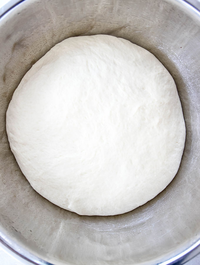 The preyzel dough boule is placed in a lightly greased bowl so it can rise.