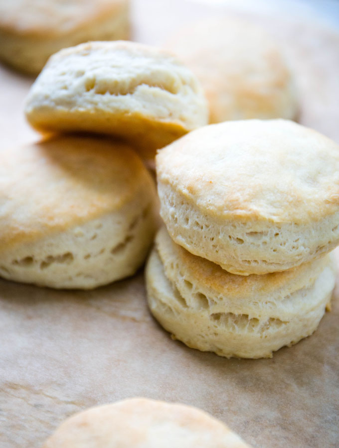 Buttermilk biscuits are stacked to show the flaky, delicious textures.