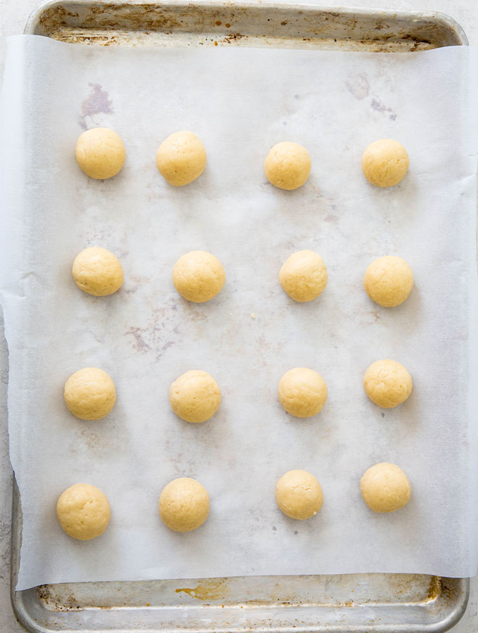 Anise cookies are rolled in a ball before they are baked in the oven.