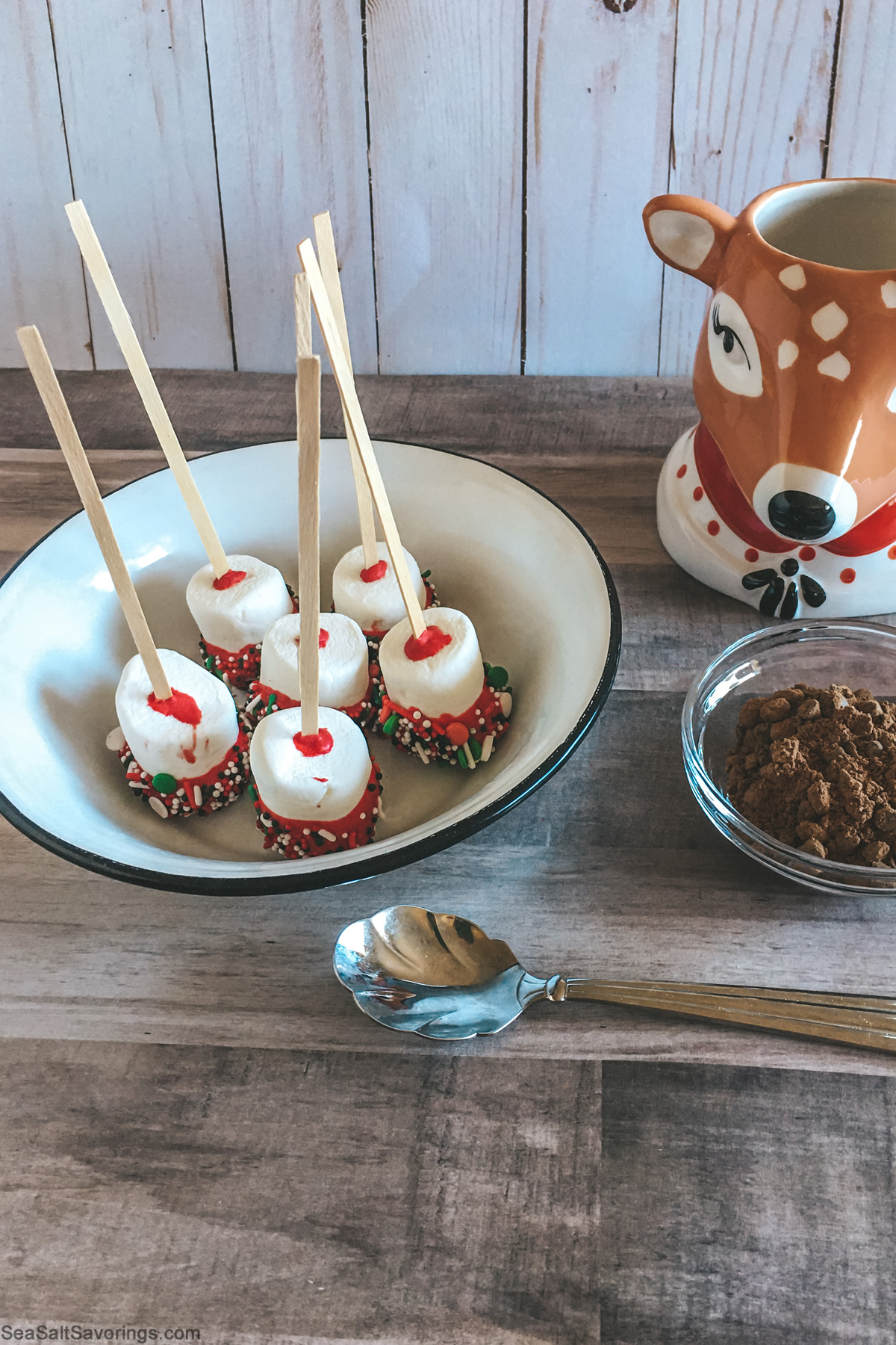  dipped marshmallows on sticks in a bowl