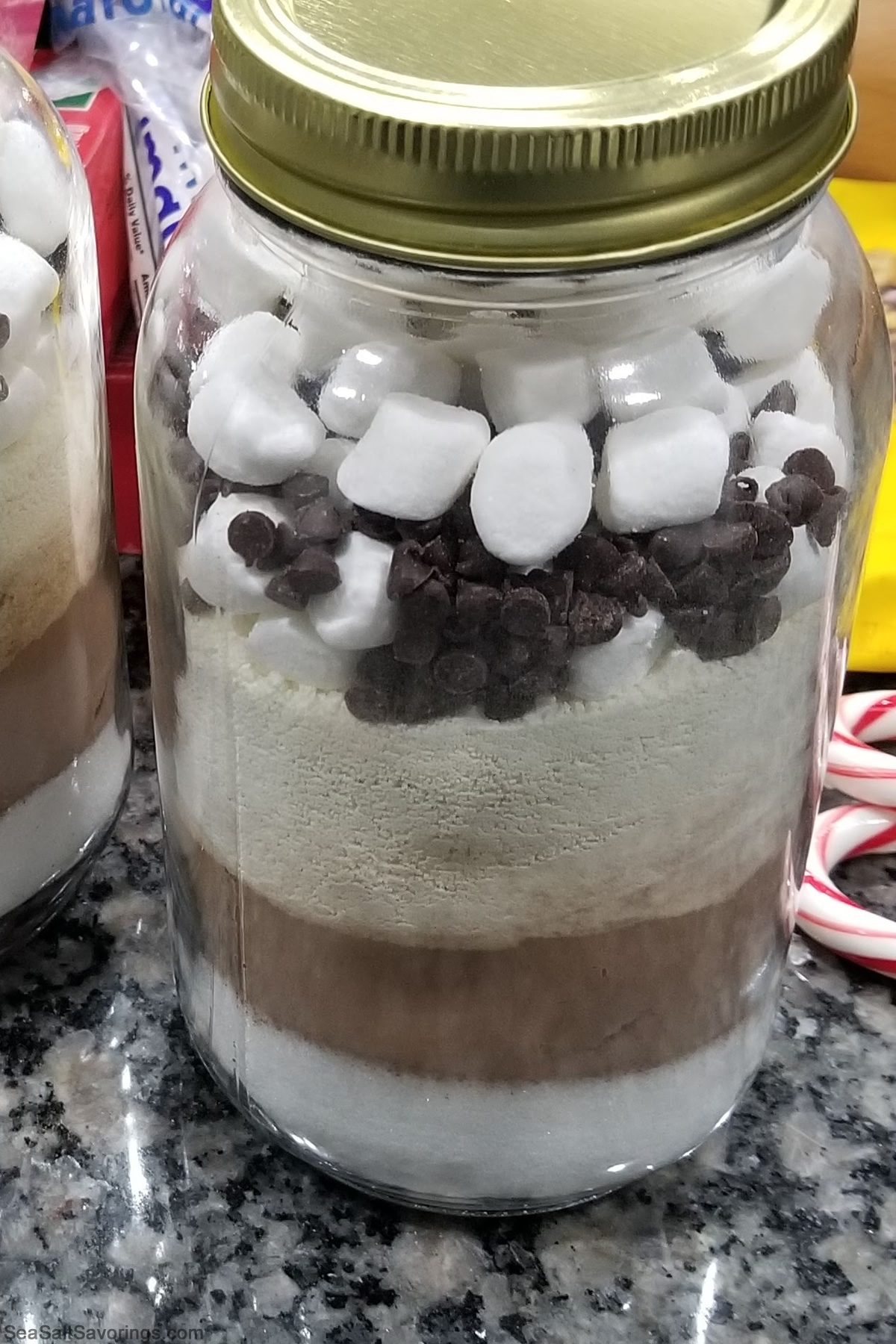 a undecorated jar full of cocoa ingredients and marshmallows