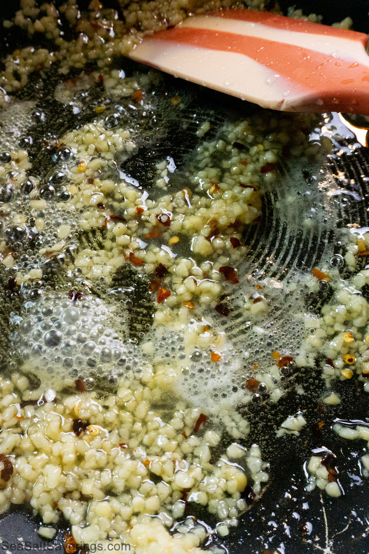 frying pan of garlic and season