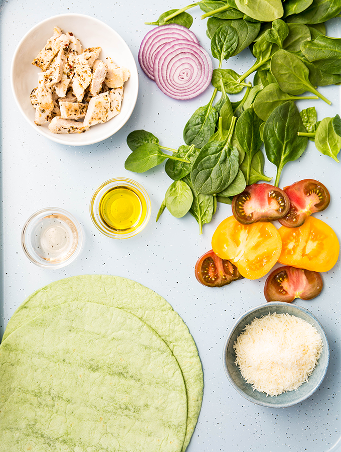 Italian chicken wrap ingredients include flour tortillas, chicken strips, spinach, and a few other fresh ingredients.